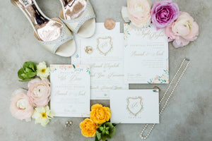 Custom wedding invitation suite flat lay with envelope and details card